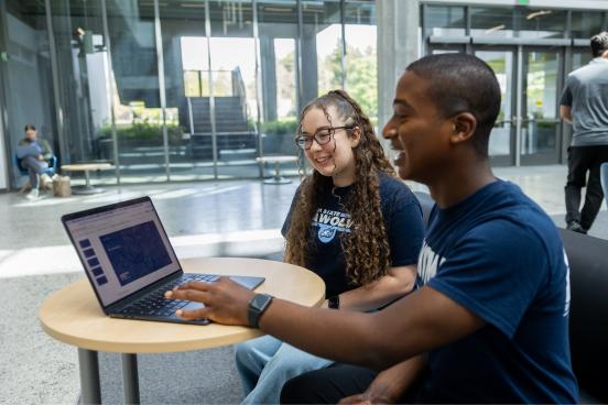 Two students looking at a computer