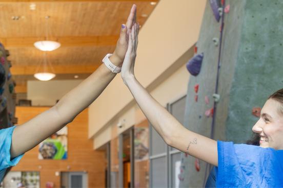 Two people high fiving