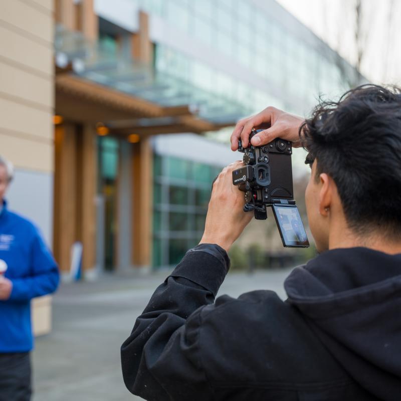 Student taking video of President Spagna