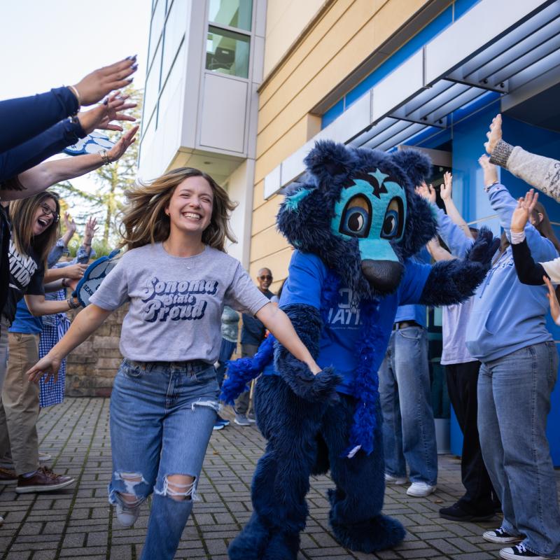 Student and Lobo running through group